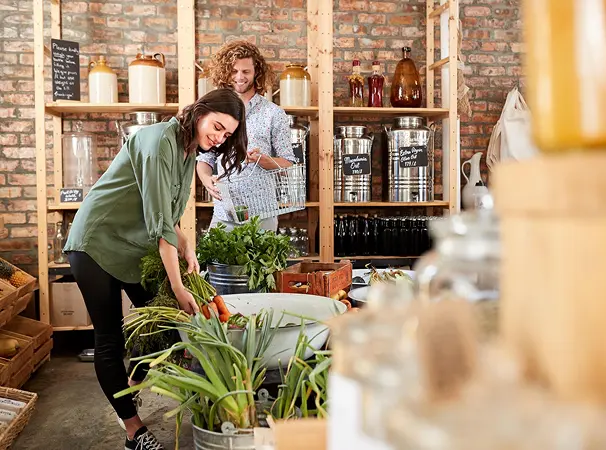 A man and woman Shopper, buying vegetables from a local produce provider.