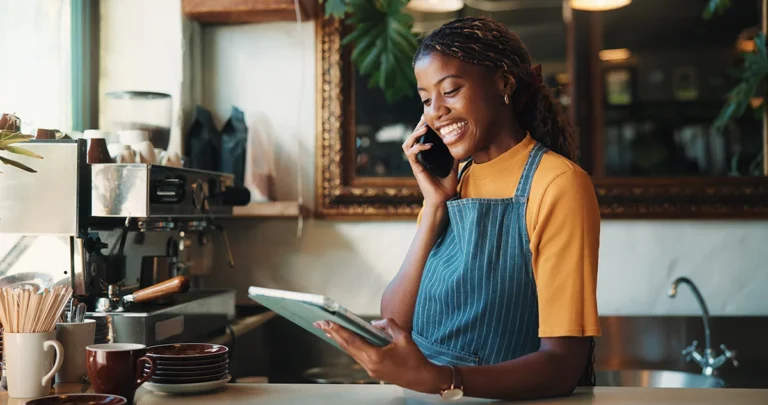 Smiling Young Woman Working as Barista in a Modern Cafe